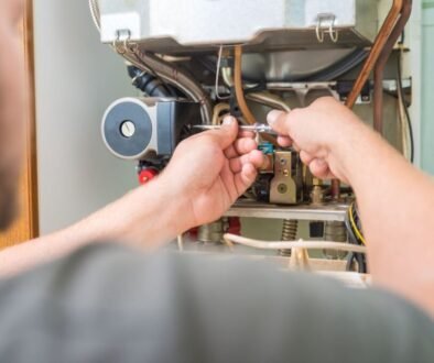 The expert is inspecting the furnace limit switch.