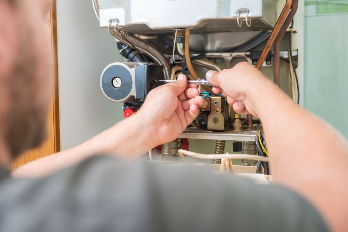 The expert is inspecting the furnace limit switch.