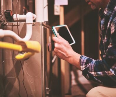 A technician checking and teaching how to troubleshoot common issues with furnace flame sensors